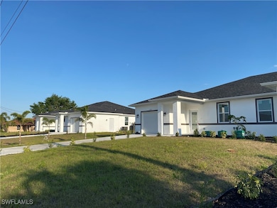 View of front of home with a garage, stucco siding