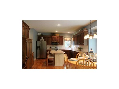 Large kitchen with center island and rich cabinetr