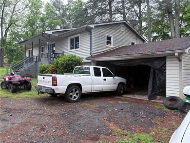 View of side of home with driveway, a garage, and 