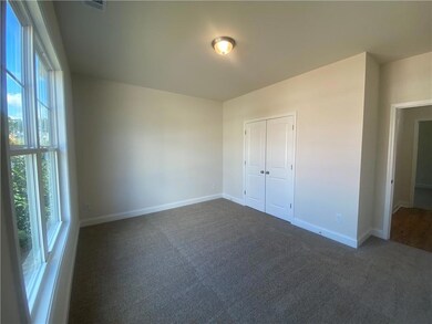 Unfurnished bedroom with carpet and a closet