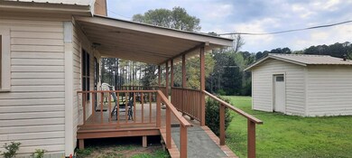 Wooden terrace with a lawn and an outdoor structur