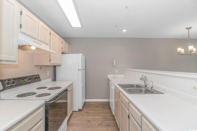 Kitchen with white appliances, sink, decorative li