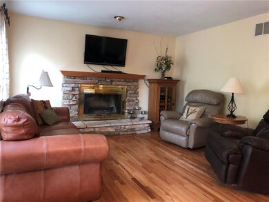 Stone fireplace is focal point of Hearth room with