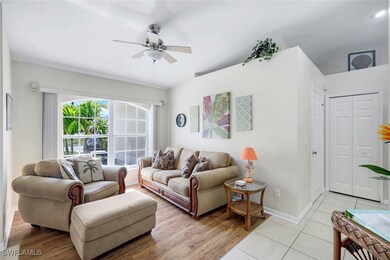 Living area featuring ceiling fan, light wood fini