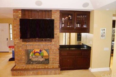 The dual-sided brick fireplace in the Living Room