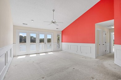 Carpeted spare room with visible vents, a textured