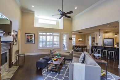 Open Floor Plan. View Across Great Room into Kitchen & Covered Patio Area.