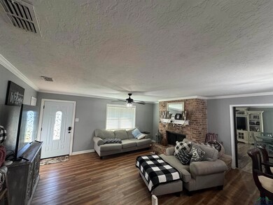 Living room featuring a textured ceiling, dark har