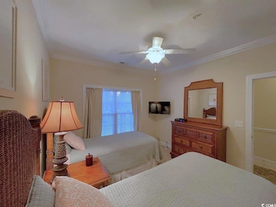 Bedroom with ceiling fan and crown molding