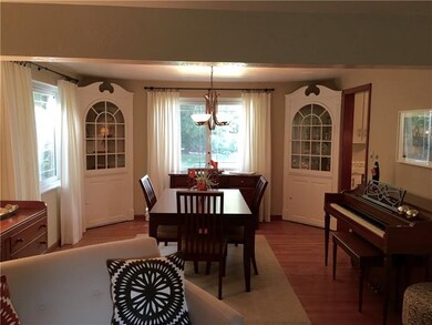 Dining room with charming built-ins and hardwood f
