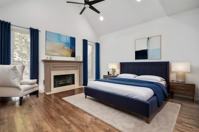 Indulge in luxury as you get cozy in the primary bedroom suite featuring gas-log fireplace and hardwood flooring adding a touch of warmth and charm