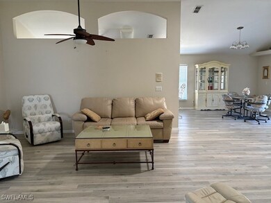 Living room featuring arched walkways, visible ven