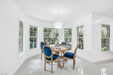Dining area with a notable chandelier and tile pat