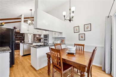 Dining space with high vaulted ceiling, a notable 