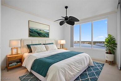 Carpeted bedroom with a water view, ornamental molding, and ceiling fan