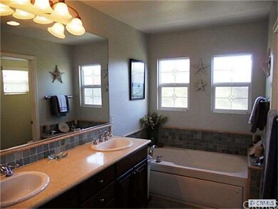 Master Bath has dual sinks, separate tiled shower 