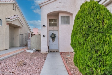 Property entrance featuring a gate and stucco siding