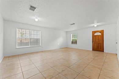 Spare room featuring a textured ceiling and light