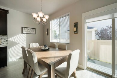 Dining room featuring light wood-type flooring and a chandelier