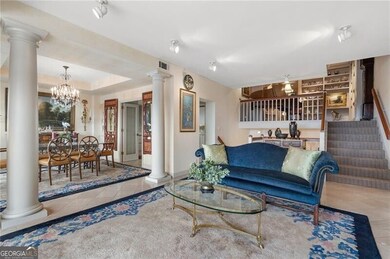 Tiled living room featuring decorative columns, vi