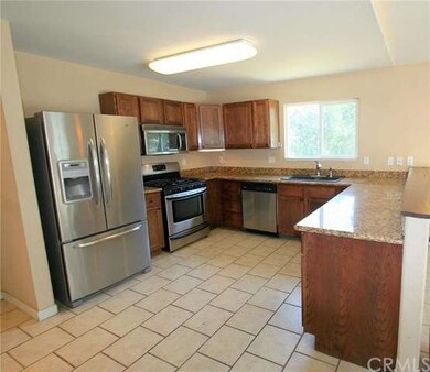 Kitchen with stainless steel appliances, tile floo