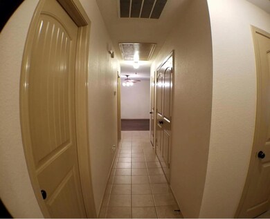 Corridor with light tile patterned flooring
