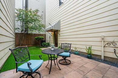 A secluded, side-entrance patio is animated by a s