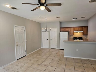 Kitchen featuring freestanding refrigerator, rang
