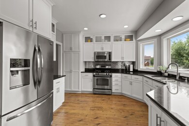 Remodel of the kitchen included custom cabinetry with soft-close features. Decorative upper cabinetry w/accent lighting.