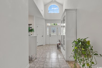 Foyer with high vaulted ceiling