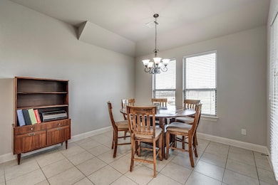 Dining area with baseboards, vaulted ceiling, a no