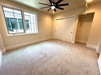 Unfurnished bedroom with a closet and light carpet