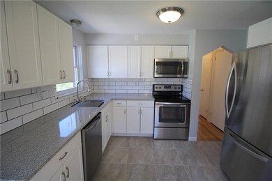 Gorgeous new kitchen with crisp white cabinetry, g