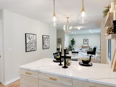 Close up of cabinetry with new brushed gold hardware and showcasing the gorgeous brushed gold lighting!
