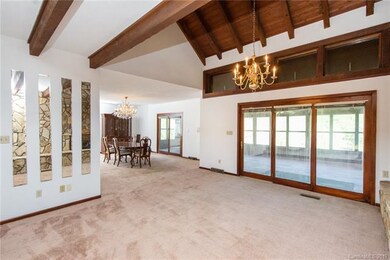Great room flowing to formal dining, with access t