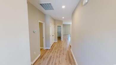 Hallway featuring light wood-style floors and recessed lighting