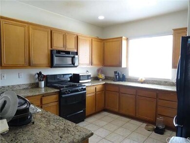 Plenty of cabinets and stone counter space, tile f