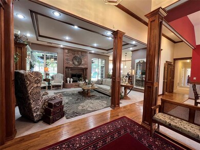 Living area featuring ornate columns, wood finishe