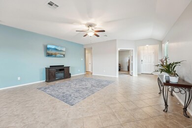 Living area with a ceiling fan, light tile patter