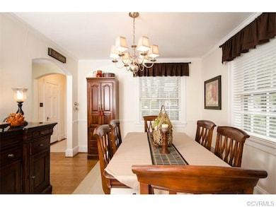 The dining room has hardwood floor, crown molding,