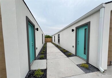 View of side of home featuring stucco siding, a patio area, and fence