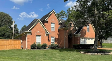 Traditional-style home with brick siding
