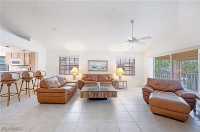 Living room featuring high vaulted ceiling, light