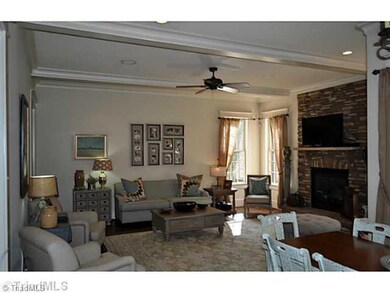 Den/Family/Great Room. The spacious den with its stone fireplace opens into the breakfast room and the kitchen.