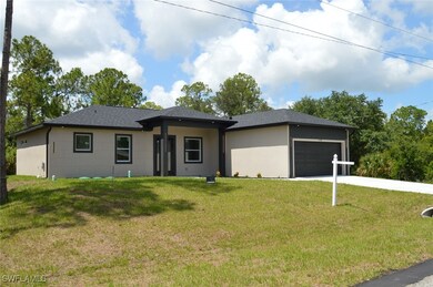 Prairie-style house with an attached garage, a front lawn, concrete driveway, and a shingled roof