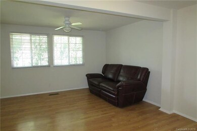Large living room overlooking quiet treed backyard