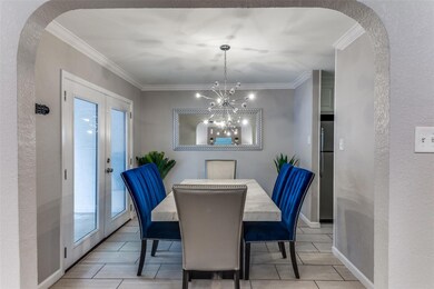 Dining room with french doors, a notable chandelie