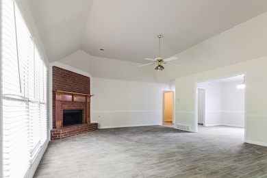 Unfurnished living room featuring lofted ceiling, 