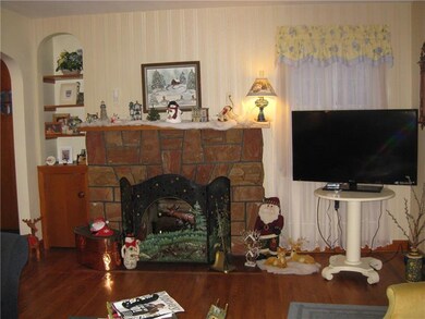 Decorated stone wood burning fireplace....note flo