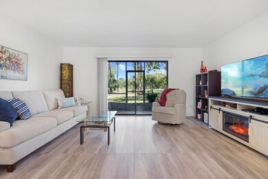 Living room featuring light wood finished floors and a glass covered fireplace